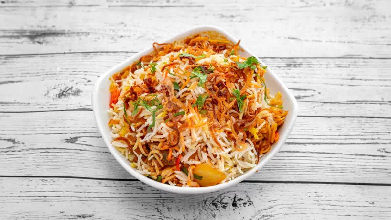 Fragrant Halal Chicken Biryani with raita at Taste of Himalayan Indian takeaway and restaurant in Rowley Regis, Blackheath near Birmingham